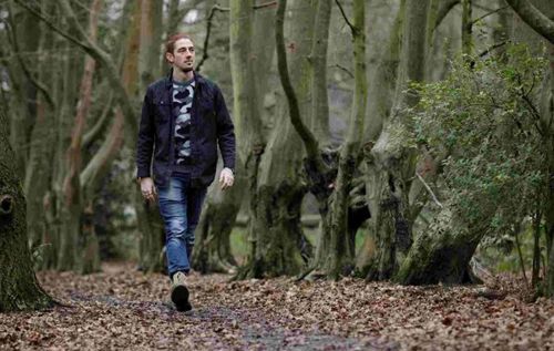 Man walking in autumnal woodlands