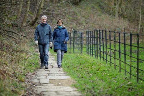 Andrew and Barbara walking down a country lane in the winter.