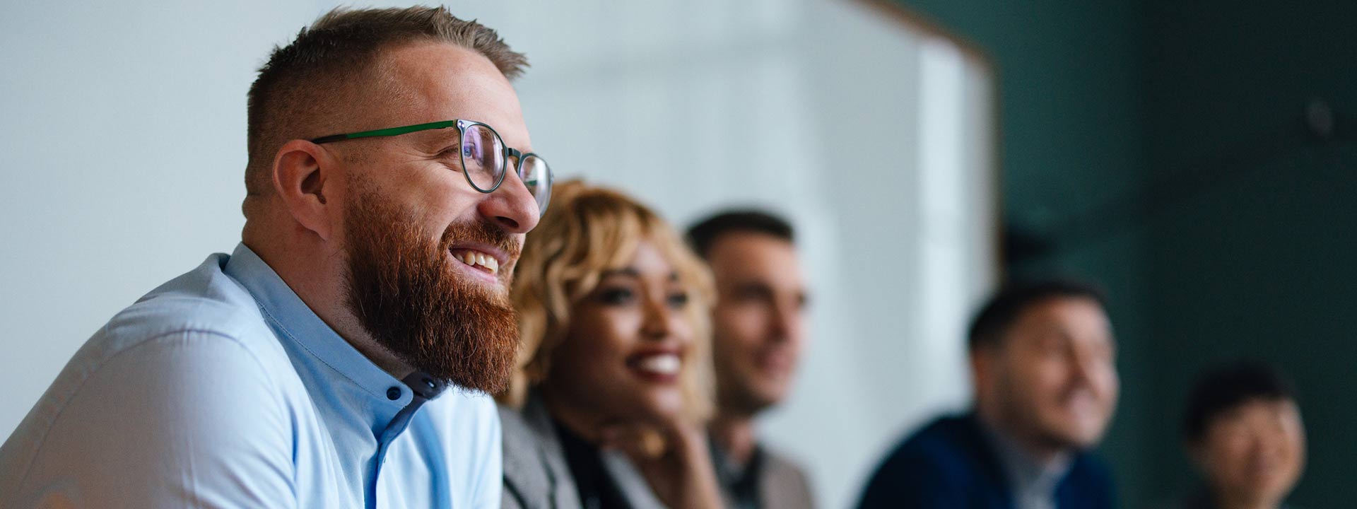 A group of smiling office workers in a meeting