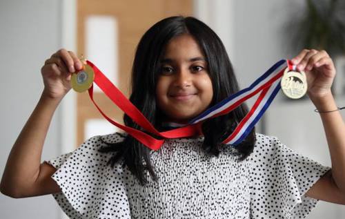 Sfiyah smiling and holding medals
