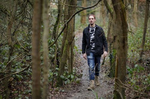 Ben, who has ankylosing spondylitis, walking through the forest.