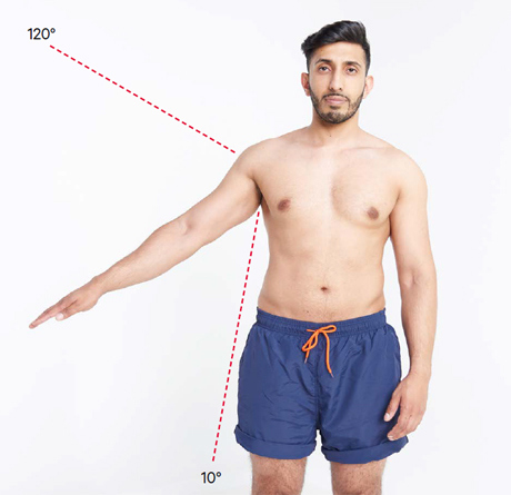 An image of a man with his arm at an angle to assess for a painful arc.
