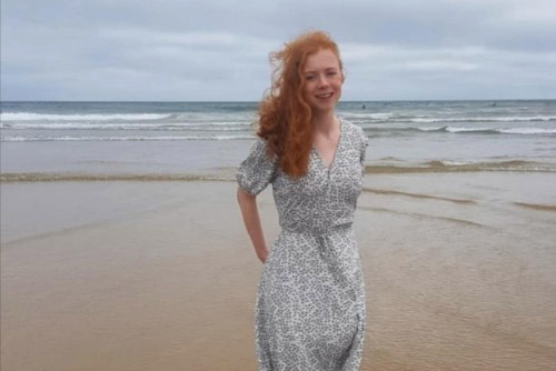 Izzie Clough stood on the beach