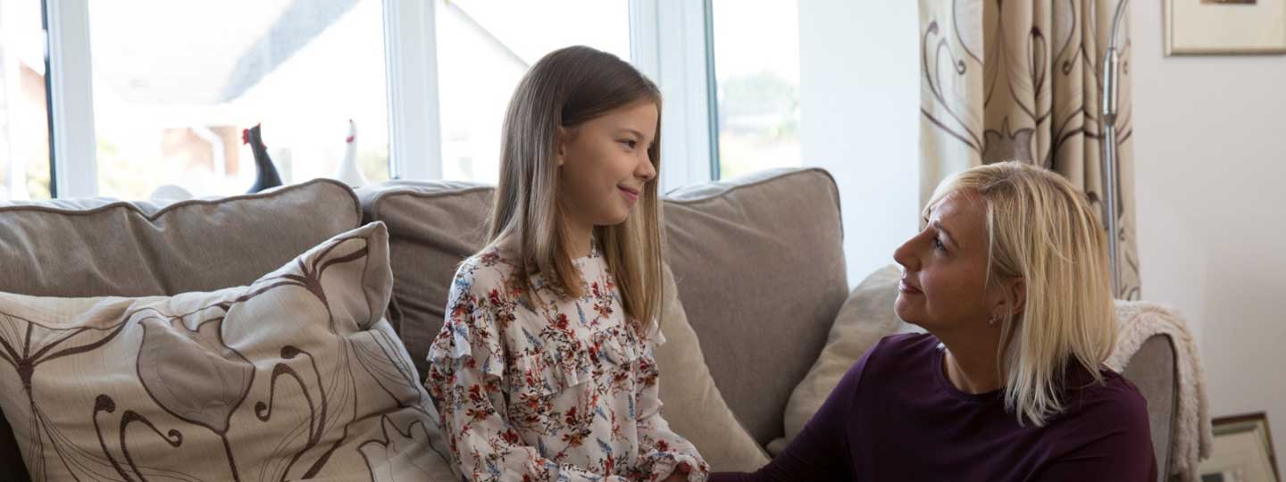 A mum with her daughter at home.