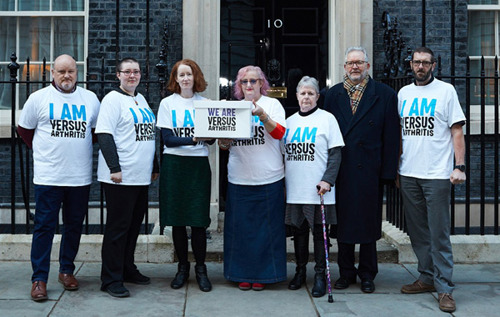 Lorraine, Ian, Brenda and Versus Arthritis staff handing in letter to 10 Downing Street
