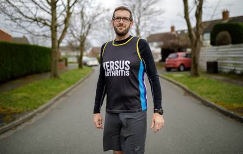 Ian wearing Versus Arthritis vest out on a run