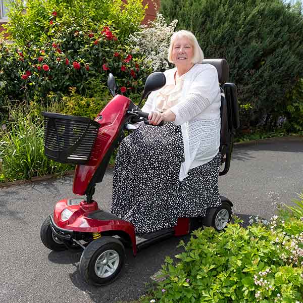 Mary on her mobility scooter in the garden