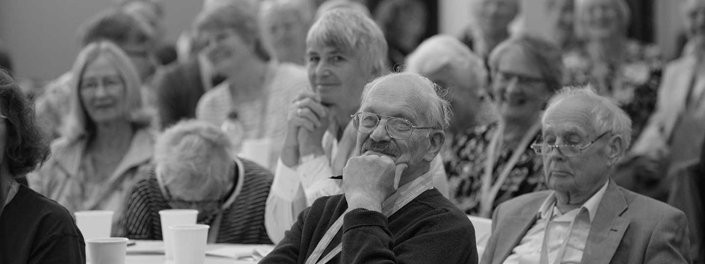 A group of older people with arthritis appreciate a talk