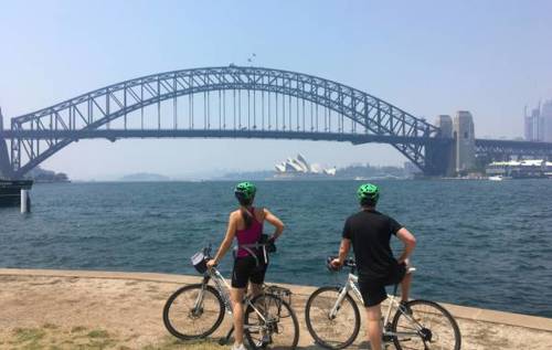 Pippa and a friend on bicycles overlooking bridge