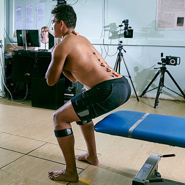 Man stretching his back in laboratory