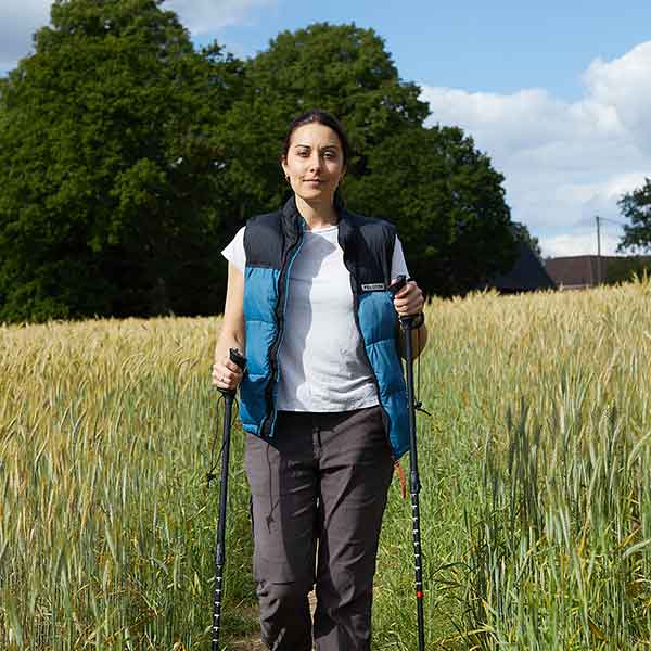 Pippa walking in a field with support sticks