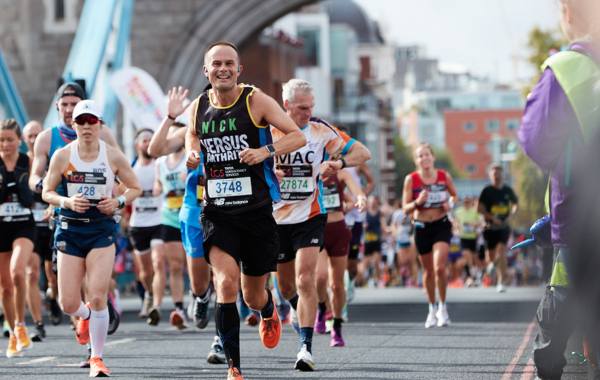 Nick running at the TCS London Marathon in 2023 wearing a Versus Arthritis vest